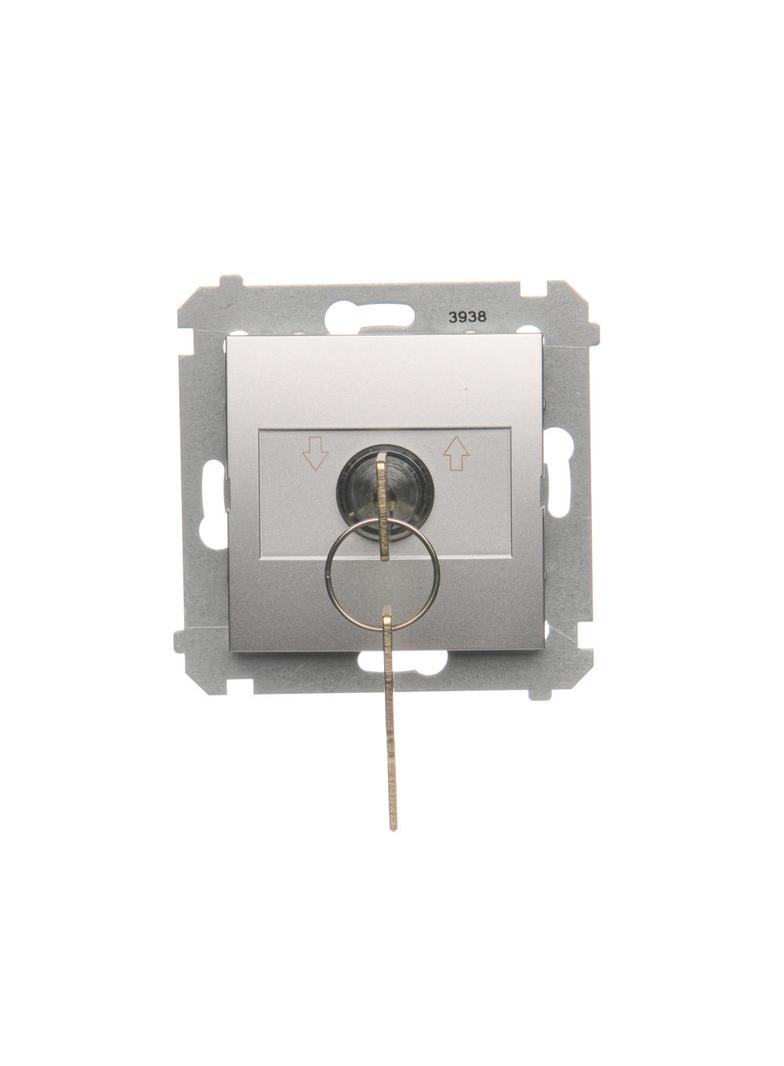 Simon 54 Łącznik na kluczyk roletowy chwilowy –przycisk 3 poz. „I-0-II'' 2 styki N/O 5A 250. Możliwość wyjęcia klucza tylko w pozycji 0 srebrny mat DPZK.01/43 KONTAKT